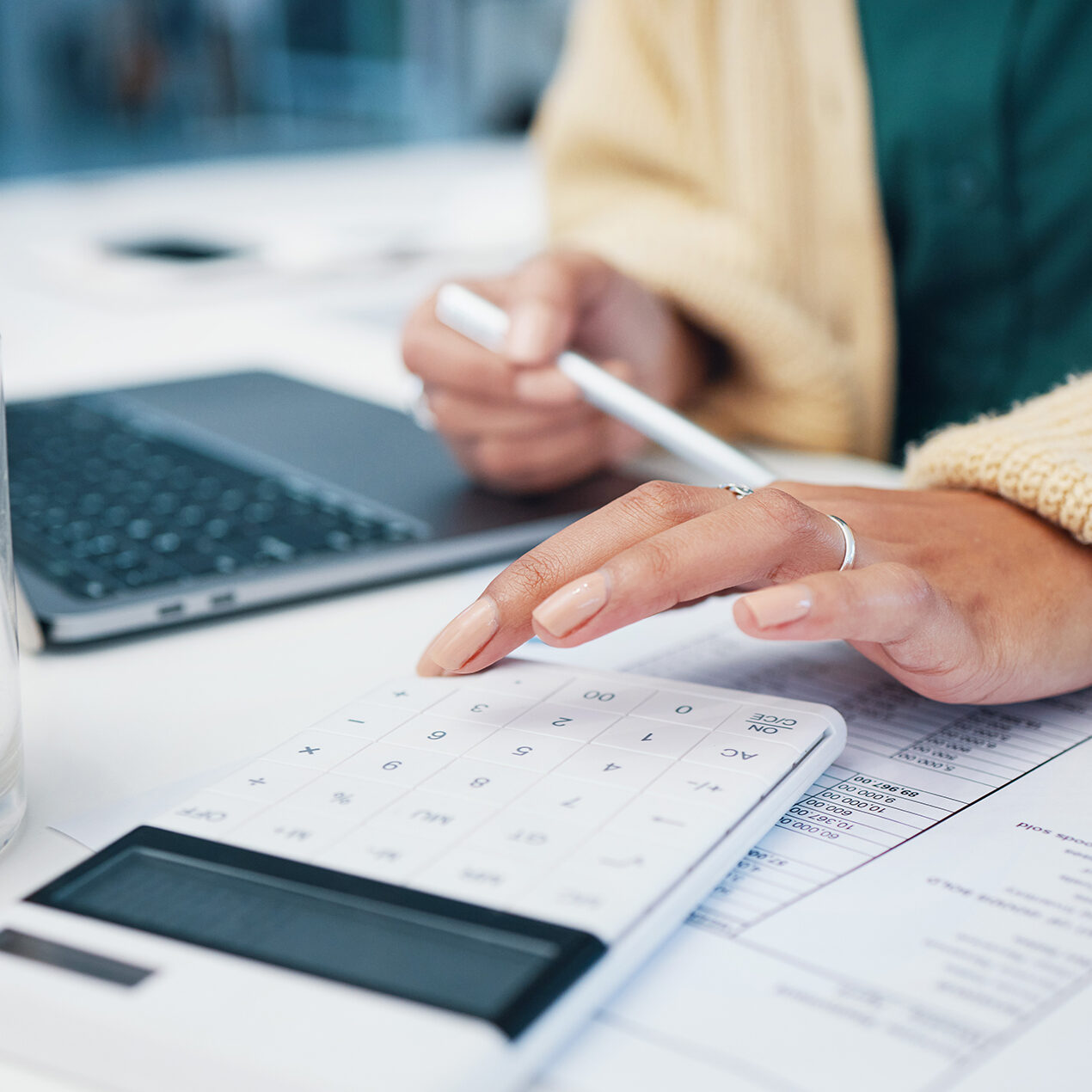 Calculator, hand and business woman with finance, tax and accountant solution in a office. Desk, profit check and planning with paperwork and money monitoring for financial report and numbers.